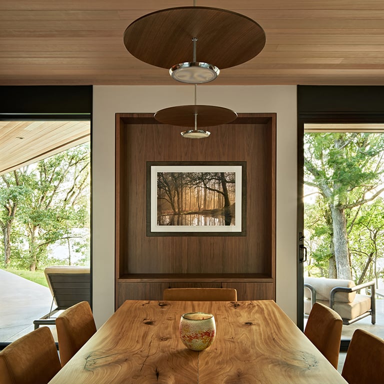A living room with floor-to-ceiling windows and polished concrete floors.