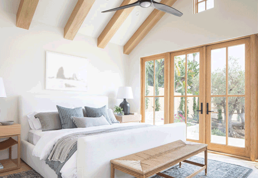 A bedroom with French doors opening to a patio.
