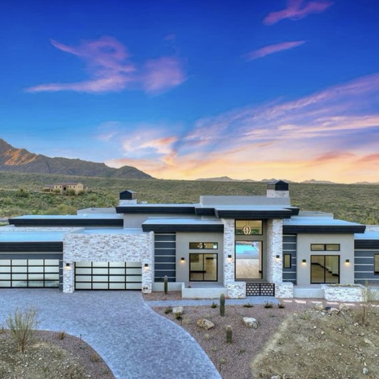 A luxury desert home rendering at sunset with a contemporary design and expansive views created by black Andersen® Aluminum Multi-Slide Doors and 100 Series Gliding and Picture Windows.