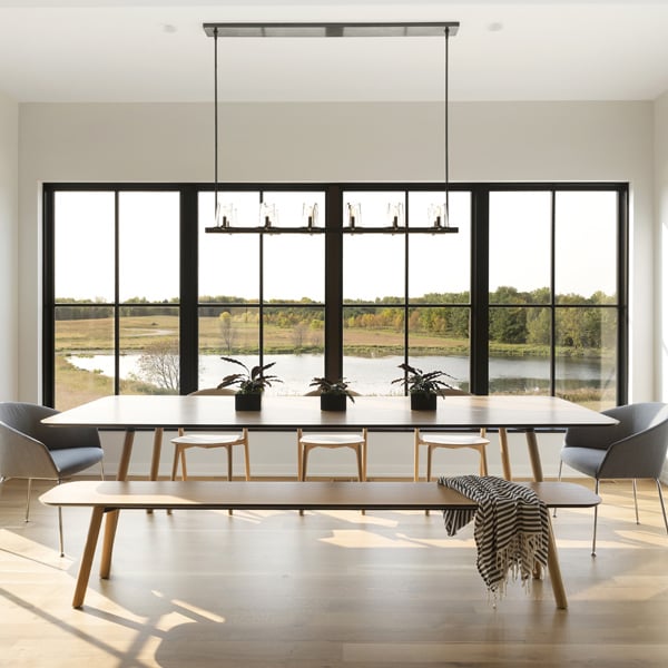 Large dining room with massive windows overlooking wetlands